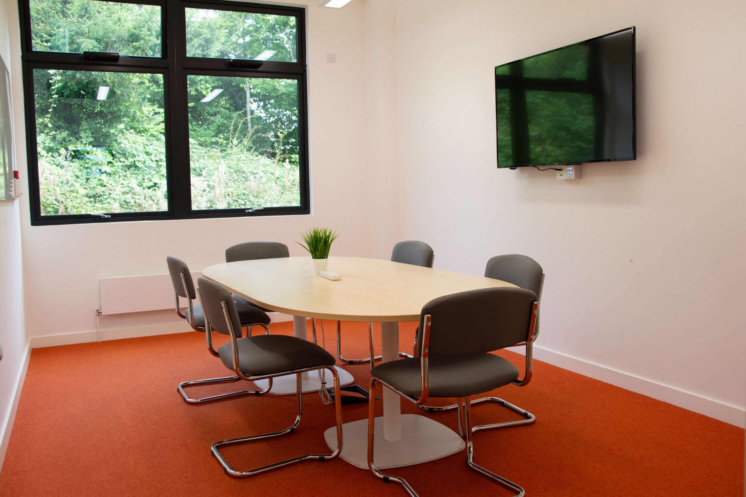 Image of meeting room with tables and chairs